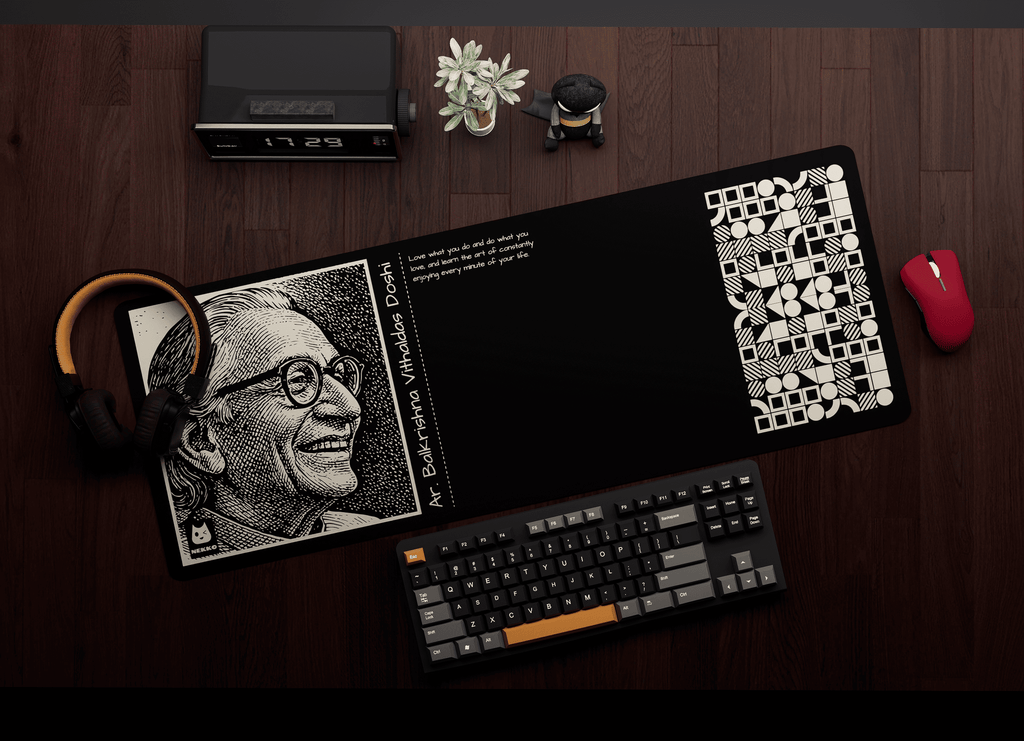 Ar. B. V. Doshi desk mat on workspace setup with keyboard and mouse